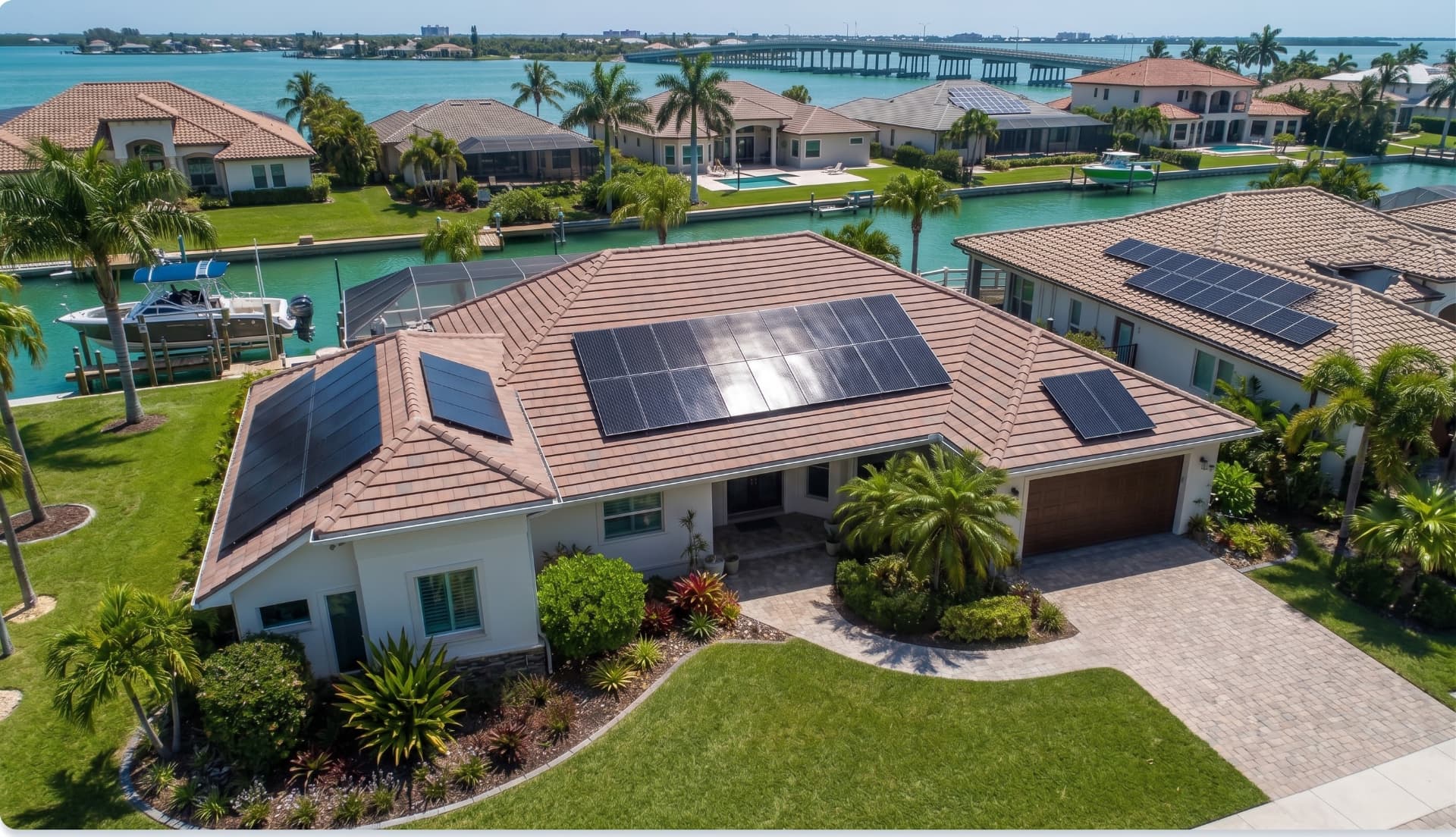Clean solar array flush-mounted on the pitched tile roof of a Florida home under a bright blue sky